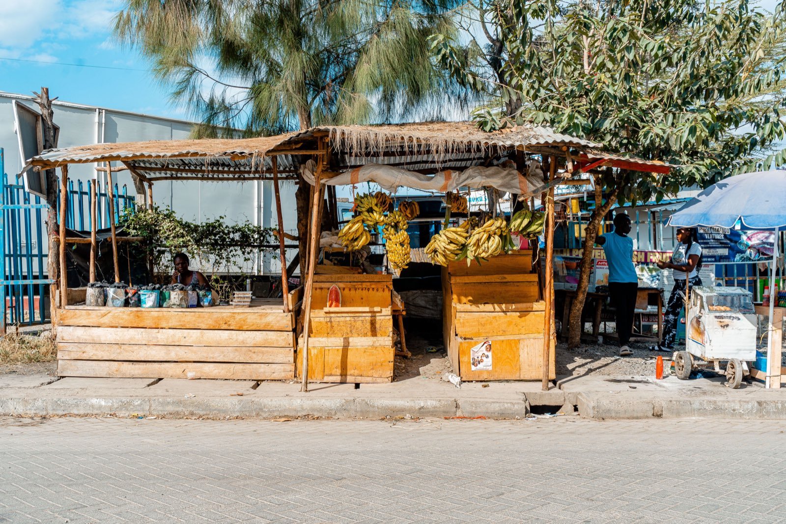 Trader tending a roadside market stall in Kenya